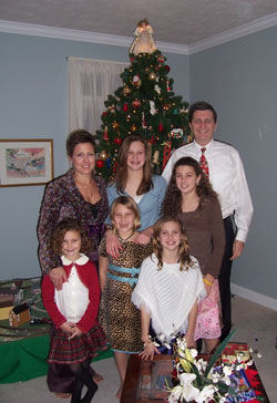 The Kelley family learned the true gifts of Catholic education during a heartbreaking time in their lives. Dana and Joe Kelley pose with their daughters, Meagan, Claire, Kate, Natalie and Beth, in their home at Christmas in 2006. (Submitted photo) 