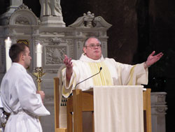Deacon John Chlopecki proclaims the Gospel during a Mass on Sept. 17, 2005, at SS. Peter and Paul Cathedral in Indianapolis during which the 25 men in the first archdiocesan deacon formation program became deacon candidates.