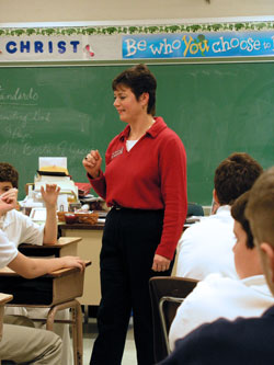 In this file photo from 2003, Laura Williams, who continues to teach middle school religion at St. Barnabas School in Indianapolis, interacts with students. St. Barnabas Parish runs its school on the stewardship model, not charging tuition to parishioners who enroll their children there. (File photo by Brandon A. Evans) 
