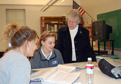 In her 56th year as an educator in the archdiocese, Benedictine Sister Louise Hoeing shares a moment with Holly Ackermann, left, and Amanda Sands, students at Bishop Chatard High School in Indianapolis. Sister Louise is the school’s director of guidance. (Submitted photo) 