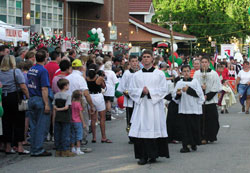 In this file photo taken on June 14, 2004, seminarian Sean Danda of St. Malachy Parish in Brownsburg leads the Marian procession along Stevens Street to Our Lady of the Most Holy Rosary Church in Indianapolis during the “Italian Street Festival.” Deacon Danda will be ordained to the priesthood by Archbishop Daniel M. Buechlein on June 27 at SS. Peter and Paul Cathedral in Indianapolis. (File photo by Mary Ann Wyand) 