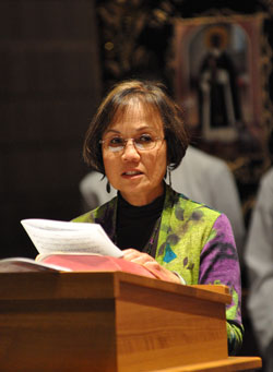 Dr. Pilar Sayoc, a member of St. Monica Parish in Indianapolis, presents a petition during the St. Martin de Porres feast day Mass on Nov. 3 at St. Thomas Aquinas Church. She also is a member of the archdiocesan Multicultural Ministry Commission. (Photo by Mary Ann Wyand)