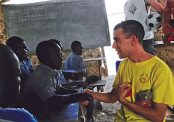 Robert Barnell of Indianapolis, an archdiocesan Refugee Resettlement Program staff member, talks with children at a parish school in Haiti last May. (Submitted photo)