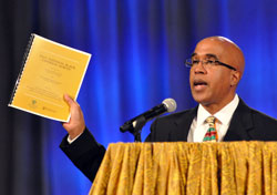Dr. Donald Pope-Davis, a sociologist and faculty member at the University of Notre Dame in northern Indiana, displays a copy of the 2011 National Black Catholic Survey during his July 19 presentation at the National Black Catholic Congress in Indianapolis. The historic national survey focused on how African-American Catholics express their faith as well as their feelings about inclusiveness in the Church. (Photo by Mary Ann Garber)