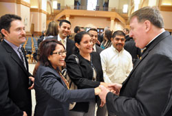 Archbishop Joseph W. Tobin greets Hispanic Catholics after the Oct. 18 press conference at SS. Peter and Paul Cathedral in Indianapolis during which he was introduced as the new archbishop of Indianapolis. Greeting him are, from left, Jesús Castillo, a member of St. Anthony Parish in Indianapolis; Gloria Guillén, Hispanic ministry assistant for the archdiocesan Office of Multiculture Ministry; Juan Manuel Gúzman, pastoral associate at St. Mary Parish in Indianapolis; Jazmina Noguera, a member of St. Lawrence Parish in Indianapolis; Roberto Márquez, pastoral associate at St. Philip Neri Parish in Indianapolis; and Reynaldo Náva, Hispanic ministry coordinator at Our Lady of the Greenwood Parish in Greenwood. (Photo by Sean Gallagher)