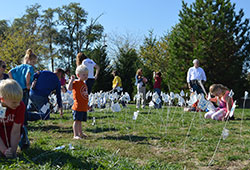 Children and other participants in an Oct. 12 “40 Days for Life” rally plant small flags in the ground in front of a Planned Parenthood abortion facility in Indianapolis. The flags represent the average 4,000 abortions that take place every working day each year in the United States. (Submitted photo)