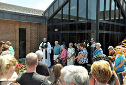 Conventual Franciscan Father Joseph West, pastor of St. Anthony of Padua Parish in Clarksville, leads a dedication service of a new preschool building for the parish’s school on July 14, 2013. An influx of students with state-funded vouchers and scholarships via scholarship-granting organizations allowed it to expand its preschool. (File photo by Natalie Hoefer)
