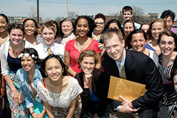 Matt Hollowell’s focus on connecting the Catholic faith to the classes he teaches and the groups he leads is one of the reasons the math and physics teacher at Cardinal Ritter Jr./Sr. High School in Indianapolis was chosen as this year’s Saint Theodora Guérin Excellence in Education Award recipient. Here he poses with one of the groups he leads—members of the school’s A Promise to Keep group. (Photo by John Shaughnessy)