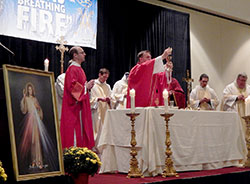 Archbishop Joseph W. Tobin raises the Eucharist on Sept. 20 during a Mass at the eighth Indiana Catholic Men’s Conference at the Indianapolis Marriott Downtown. More than 400 men attended. (Photo by Mike Krokos)