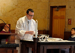 Seminarian James Brockmeier prepares the altar in the St. Thomas Aquinas Chapel at Saint Meinrad Seminary and School of Theology in St. Meinrad during a March 27 Mass. (Photo by Sean Gallagher)