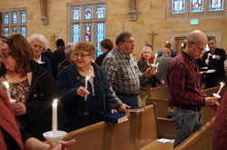 Judy and Bob LaEace, members of St. Michael the Archangel Parish in Indianapolis, hold candles during a March 11 ecumenical prayer service at their parish’s church. St. Michael and three other nearby Christian congregations on Indianapolis’ west side have deepened their ecumenical relationship through prayer and discussion of race relations. (Submitted photo)