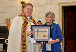 On Nov. 9 in the Blessed Sacrament Chapel of the SS. Peter and Paul Cathedral in Indianapolis, Archbishop Joseph W. Tobin presents Wendy Braun of St. Simon the Apostle Parish in Indianapolis with the archdiocesan lay ministry certificate she earned. Four others also received the certificate: Anita Bardo of St. Rita Parish, Michael Clouse of St. Christopher Parish and Therese Hartley of St. Luke the Evangelist Parish, all in Indianapolis, and Franciscan Sisters of the Immaculate Heart of Mary Sister Ushatta Mary of Our Lady of the Greenwood Parish in Greenwood. (Photo by Natalie Hoefer)