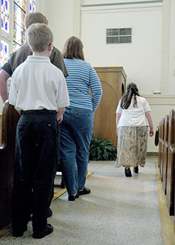 People wait in line outside of a confessional in Our Lady of the Most Holy Rosary Church in Indianapolis. The importance of the sacrament of penance in the life of faith is being emphasized in the Archdiocese of Indianapolis during the Holy Year of Mercy. Some archdiocesan parishes are making the celebration of the sacrament more widely available during “24 Hours for the Lord” on March 4-5. (File photo by Sean Gallagher)