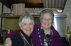 Longtime Cathedral Soup Kitchen volunteer Dee Morley, right, shares a fun moment with Margie Pike, the director of the soup kitchen for the poor that is a ministry of SS. Peter and Paul Cathedral in Indianapolis. (Photo by John Shaughnessy)