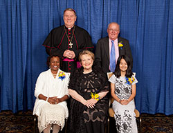 Catholic Charities Indianapolis presented four individuals with Spirit of Service Awards during an April 27 dinner in Indianapolis. Award recipients, seated from left, are Domoni Rouse, Phyllis Land Usher and Htoo Thu. Standing are Archbishop Joseph W. Tobin and award winner Tim Hahn. (Submitted photo by Rich Clark)