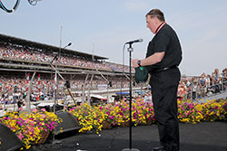 Archbishop Joseph W. Tobin offers an invocation prayer on May 24, 2015, prior to the start of the 99th running of the Indianapolis 500 in Indianapolis. Hundreds of thousands of people at the track join him in prayer, and millions more hear him on radio and television broadcasts of the race. (IMS Photo Archive)