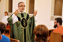 Father Joseph Moriarty gives a homily during a June 16 Mass at the chapel of Bishop Simon Bruté College Seminary in Indianapolis during Bishop Bruté Days, an annual summer vocations camp and retreat experience for teenage boys. Father Moriarty, who previously served as the archdiocesan-sponsored seminary’s vice rector, was recently appointed its rector, succeeding Father Robert Robeson, who served as rector since its founding in 2004. (Photo by Sean Gallagher)