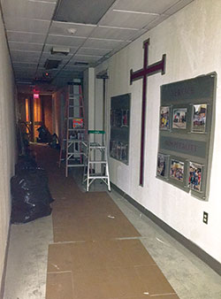 Cardboard, bags of trash and ladders are seen in the hallway where a fire was intentionally set on May 10 toward the back of the sanctuary of St. Barnabas Church in Indianapolis. (Photo by Natalie Hoefer)