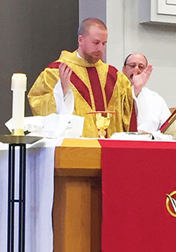 Father Kyle Rodden celebrates the Eucharist during a Mass at St. Monica Parish in Indianapolis, where he is associate pastor. (Photo by Natalie Hoefer)