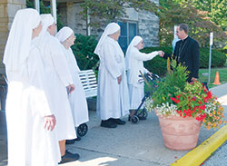 Little Sisters of the Poor Sister Gloria Thomas, left, Mother Francis Gabriel, and Sisters Alexis, Cecelia and Marthe welcome Archbishop Charles C. Thompson to the St. Augustine Home for the Aged in Indianapolis on Aug. 30. (Photo by Natalie Hoefer)