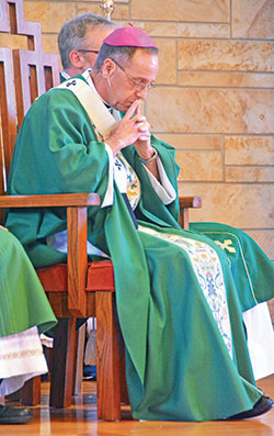 Archbishop Charles C. Thompson prays during a July 30 Mass at Our Lady of Perpetual Help Church in New Albany. In an interview with The Criterion, Archbishop Thompson emphasized the importance of prayer in discerning a vocation. (Photo by Natalie Hoefer)