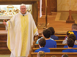 As pastor of St. Roch Parish in Indianapolis, Father James Wilmoth has always had a close connection with the students at the parish school—a connection that led to the students raising more than $26,000 earlier this year to help a Catholic school in Texas devastated by Hurricane Harvey in August of 2017. (Submitted photo)
