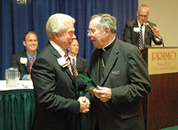 Archbishop Daniel M. Buechlein presents a Catholic Community Foundation (CCF) service award to St. Luke the Evangelist parishioner L. H. Bayley of Indianapolis, who previously served as president of the CCF board of trustees, during an annual meeting of the board on Oct. 24, 2007, in Indianapolis. (File photo by Sean Gallagher)