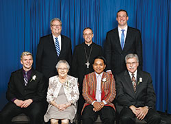 Catholic Charities Indianapolis presented four individuals with Spirit of Service Awards during an April 24 dinner in Indianapolis. Award recipients, seated from left, are Michael Isakson, Rita Kriech, Paul Hnin and Dr. Michael Patchner. Standing, from left, are David Bethuram, executive director of the archdiocese’s Catholic Charities, Archbishop Charles C. Thompson and keynote speaker Joe Reitz. (Submitted photo by Rich Clark)