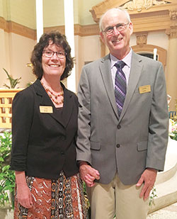 Linda and Bradley Butler stand before the altar of SS. Peter and Paul Cathedral in Indianapolis. Bradley was brought into full communion with the Catholic Church in the cathedral during the Easter Vigil Mass on March 31. Linda, his wife of 38 years, was his sponsor. (Submitted photo) 