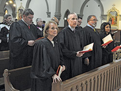 Judges worship during the Oct. 1 Red Mass of the St. Thomas More Society of Central Indiana celebrated at St. John the Evangelist Church in Indianapolis. The judges are, from left, Marion County Superior Court Judge Clark Rogers; Chief Judge Robyn Moberly of the U.S. Bankruptcy Court; Indiana Supreme Court Justices Mark Massa (partially obscured) and Geoffrey Slaughter; Marion County Magistrate David Hooper (partially obscured); Marion County Superior Court Judge Calvin Hawkins; and U.S. District Court Judge Tanya Walton Pratt. (Photo by Sean Gallagher)