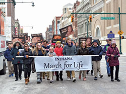 Students of Lumen Christi Catholic School in Indianapolis carry a banner as they process up Meridian Street in Indianapolis on Jan. 22, leading the second Indiana March for Life. (Photo by Natalie Hoefer)