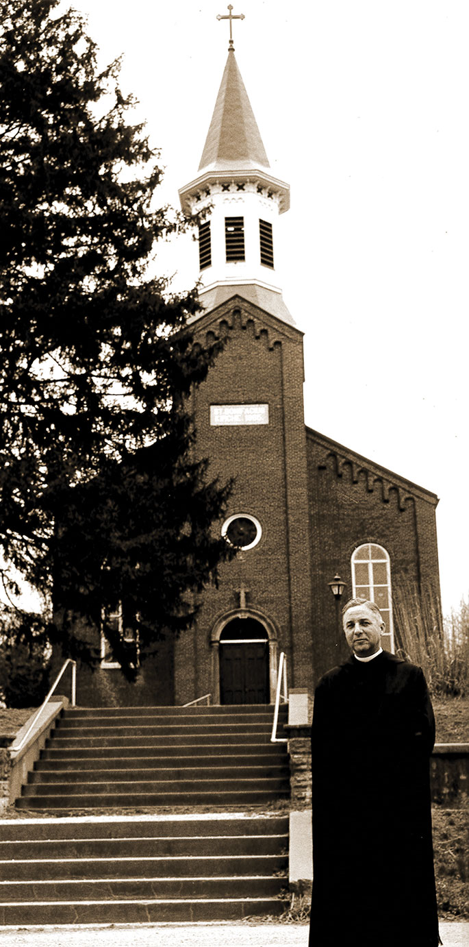 This photo of Benedictine Father Edwin Miller standing near St. Boniface Church in Fulda was taken as the parish, founded in 1847, prepared to celebrate the centennial of its church building in 1965. A special centennial Mass was celebrated by Archbishop Paul C. Schulte and Benedictine Archabbot Bonaventure Knaebel, of Saint Meinrad Archabbey on May 2, 1965. The church was listed on the National Register of Historic Places in 1980.