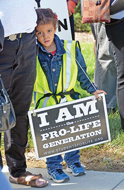 Larelle Thompson, 3, wears a sign during a 40 Days for Life kickoff event at the Planned Parenthood abortion facility in Indianapolis on Sept. 26, 2018. Her life was saved from abortion at the same facility three-and-a-half years prior. (File photo by Natalie Hoefer)
