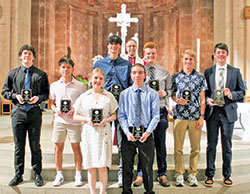 Archbishop Charles C. Thompson poses for a photo with recipients of the Spirit of Youth Award from the archdiocese’s Catholic Youth Organization (CYO). The youths were honored during the CYO’s Volunteers Awards Ceremony at SS. Peter and Paul Cathedral in Indianapolis on May 2. (Photo by Michaela Ward of the CYO)