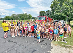 The children who participated in the Totus Tuus summer program in the Tell City Deanery line up for a group photo on the last day of the program, which included the fun of a water balloon fight and a slip-and-slide. (Submitted photo)