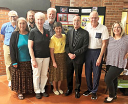 Members of the archdiocese’s Creation Care Ministry pose with Archbishop Charles C. Thompson at St. Thomas Aquinas Parish in Indianapolis on Sept. 26, the day the archbishop celebrated the archdiocese’s annual Green Mass there. Posing in the front row are Rosemary Spalding, left, Sharon Horvath, Benedictine Sister Sheila Fitzpatrick, Archbishop Charles C. Thompson, Joe Shierling and Laura Sheehan. In the back row are Andy Pike, left, Andy Miller and John Mundell. Creation Care Ministry members not in the photo are Sarah Mundell and Julie Reyes. (Submitted photo)