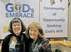 Heather Simon, left, and her mother, Colleen Simon, share smiles as they pose for a photo behind the counter of God’s Embrace Coffee Shop, a business that strives to help people with disabilities find their purpose. (Photo by John Shaughnessy)