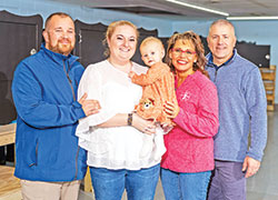 Jordan and Gabrielle Bullard, left, smile with their baby, Lynne Marie, together with Monica Kelsey, founder of Safe Haven Baby Boxes (SHBB), and her husband Joe in Woodburn, Ind., during the opening of SHBB’s new baby box production facility on Dec. 2, 2023. The Bullards adopted Lynne a month after she was surrendered in a Safe Haven Baby Box in Indiana in February 2023. (Submitted photo by Jason Mann of J Michael Photography, LLC)