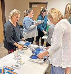 Teachers and staff of St. Matthew the Apostle School in Indianapolis assemble “birthday-in-a-box” kits for the food pantry at St. Philip Neri School in Indianapolis, a Mother Theodore Catholic Academy, on Dec. 5. (Submitted photo)