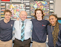 The connection between Mark Stratton, the visual arts teacher at Roncalli High School in Indianapolis, and his students shows in the smiles shared with Elyas Williams, left, Alex Plahitko and Carrianne Sabina. Stratton is this year’s recipient of the Saint Theodora Excellence in Education Award, the highest honor given to an educator in the archdiocese. (Photo by John Shaughnessy)