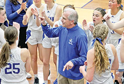 Head coach Dan Wagner shares a moment of joy with the players on the girls’ varsity basketball team of Bishop Chatard High School in Indianapolis during the 2023-24 season. (Photo courtesy of Angie Tragesser)