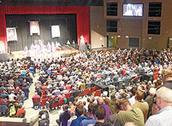 Father Jonathan Meyer celebrates Mass with concelebrating priests on Feb. 17 at East Central High School in St. Leon during the ninth annual E6 Catholic Men’s Conference sponsored by All Saints Parish in Dearborn County. More than 1,200 men took part in the event. (Photo by Sean Gallagher)