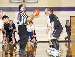 Priests and seminarians of the Lafayette diocese get set for the jump ball to start the first annual “Cassock Classic” basketball game. A crowd of nearly 950 fans turned out for the Jan. 3 event, organized by the Frassati Society. (Photo by Bob Nichols)