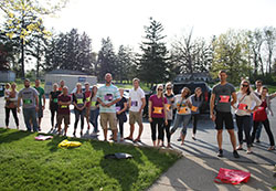 The Fort Wayne Frassati road rally brought out a friendly competitive spirit between young adults from Our Lady of Good Hope Parish. Participants smile before they were given a list of the challenges to map out a strategy before the start of the race. After the allotted two minutes of planning, all the teams ran to their cars and raced to complete the challenges.