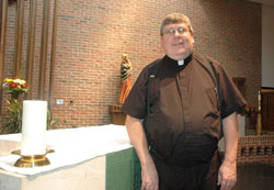 Father Anthony Volz poses for a photograph in Christ the King Church in Indianapolis, where he has served as pastor for more than five years. (Photo by Sean Gallagher)