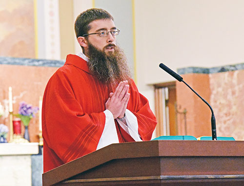 Transitional Deacon Bobby Vogel proclaims the Gospel during an Aug. 14, 2023, Mass in the chapel of the St. Joseph Retreat and Conference Center in Tipton County in the Lafayette, Ind., Diocese. The Mass was part of the annual archdiocesan seminarian convocation. (File photo by Sean Gallagher)