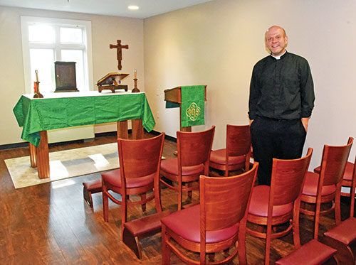 Father Andrew Syberg stands on Aug. 1, 2023, in a chapel for first-year seminarians at Bishop Simon Bruté College Seminary in Indianapolis. He was recently appointed as the new rector of the archdiocesan-sponsored seminary. (File photo by Sean Gallagher)