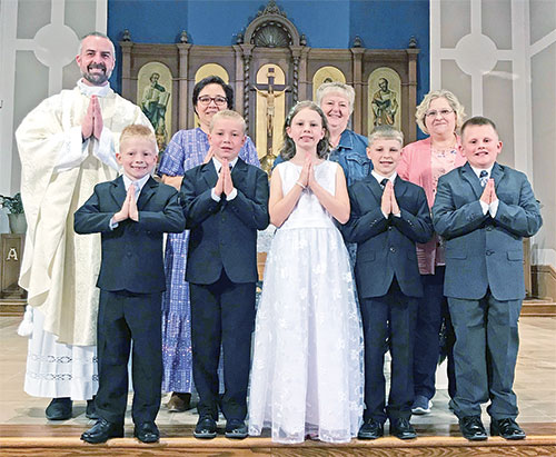 The children at St. Mary Parish in Rushville who received their first Communion on May 5 in the parish church line up for a photo with the people who supported them in their path to the sacrament. (Submitted photo)