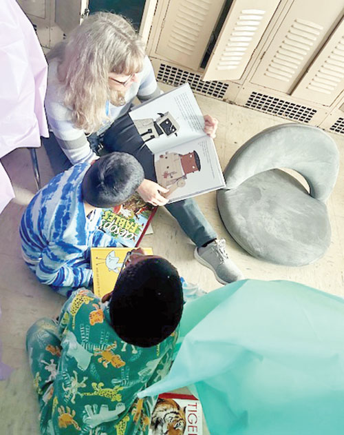 Pam Breedlove, a literacy coach at Central Catholic School in Indianapolis, reads to third-grade students during Camp Read A Lot, a celebration of the school’s dramatic improvement in student literacy, with a 51.7 percentage-point increase in its Indiana Reading Evaluation and Determination (IREAD) testing in the 2024-25 school year. (Submitted photo)