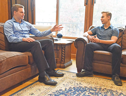 Seminarians Dominic Pavey, left, and Max Ecoff chat on Oct. 21 at Bishop Simon Bruté Seminary in Indianapolis where they are respectively in their second and first years of priestly formation. Both members of Our Lady of the Most Holy Rosary Parish in Indianapolis, they noted that seeing happy and holy priests and seminarians helped them in their discernment of a possible vocation to the priesthood. (Photo by Sean Gallagher)